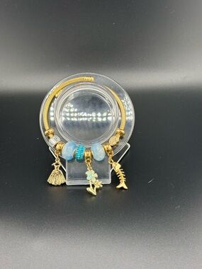 Gold and Light Blue Charm Bracelet with Floral and Shell Pendants